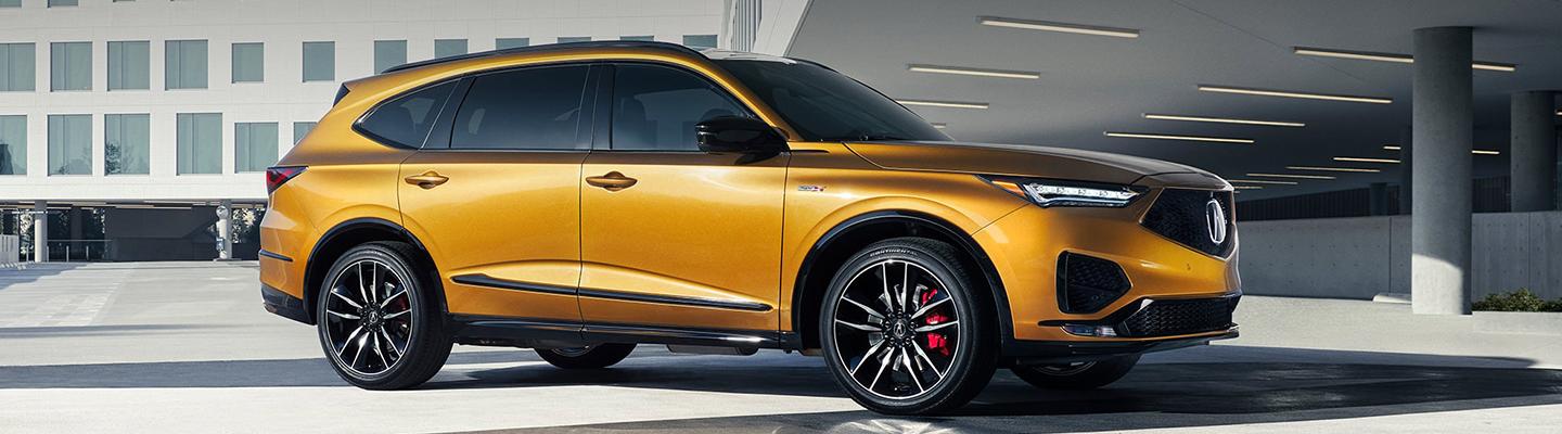 Side profile of an orange Acura MDX Type S