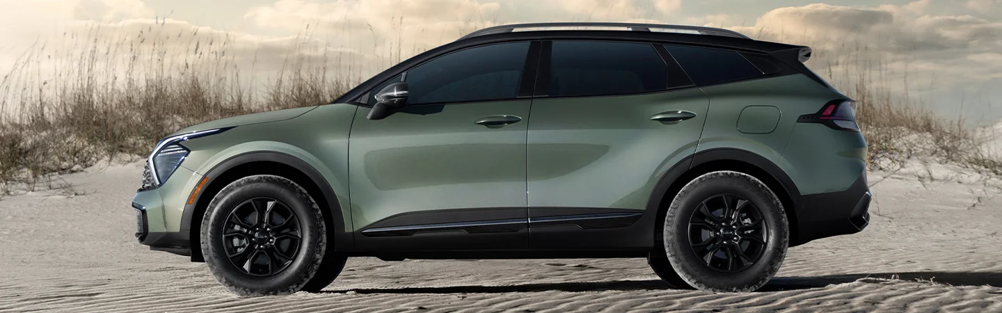 Side view of a parked 2025 Kia Sportage on the sand