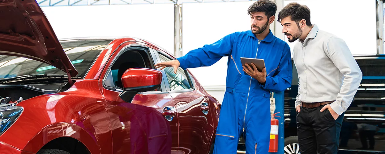 Service mechanic showing a customer a clipboard