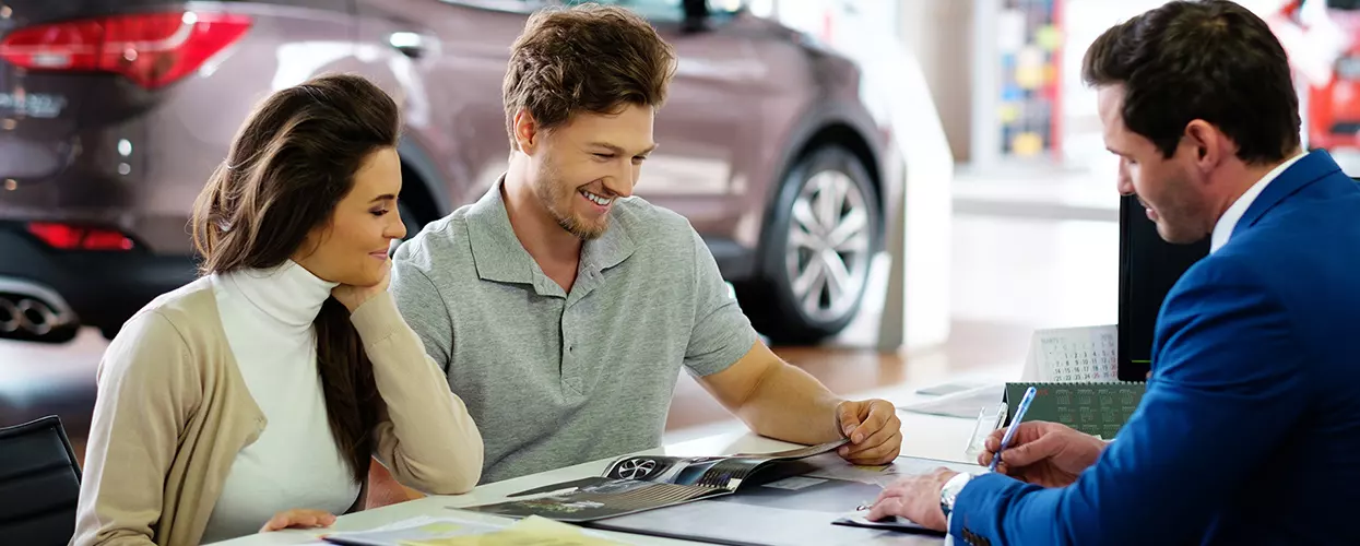 Car salesman talking to a customer about a contract
