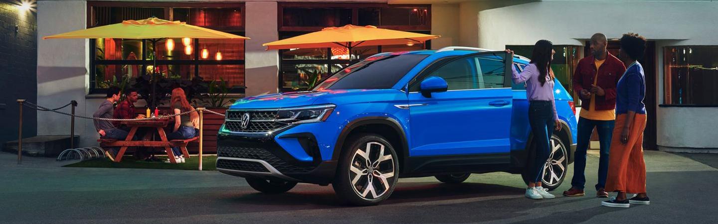 People gathered next to 2022 Volkswagen Taos