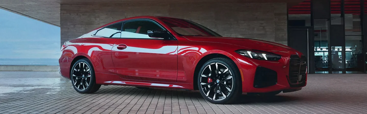 2025 BMW 4 Series Coupe side front in red