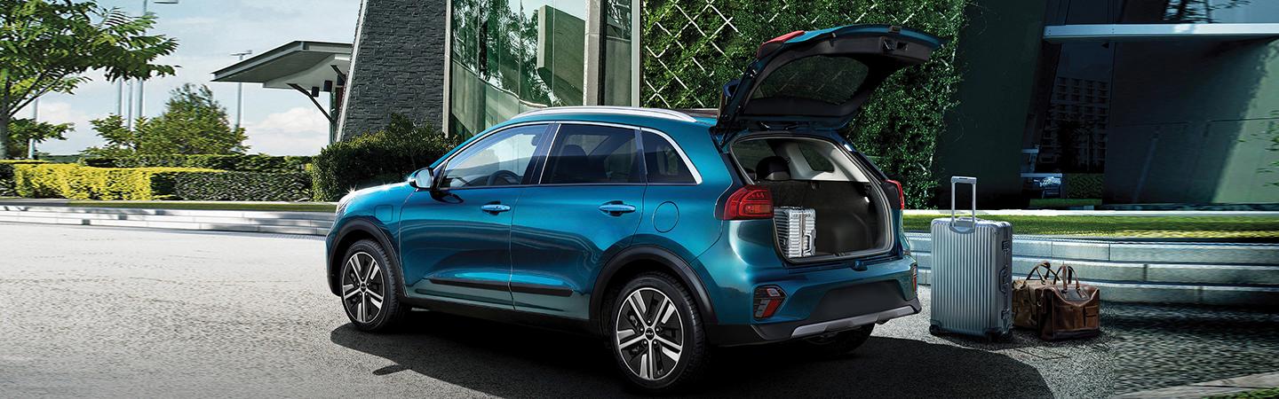 2022 Kia Niro Hybrid rear view with hatch open with baggage on curb