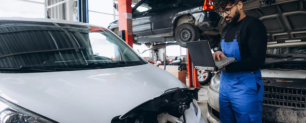 Service mechanic running a diagnostic on an electric vehicle