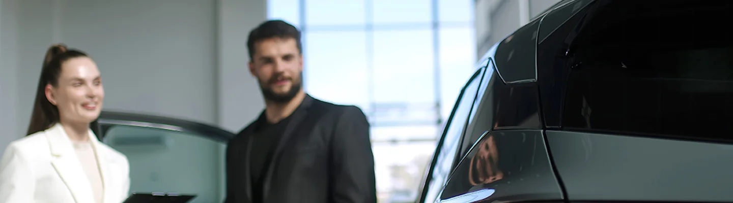 Car salesman showing a person a new Chevrolet vehicle