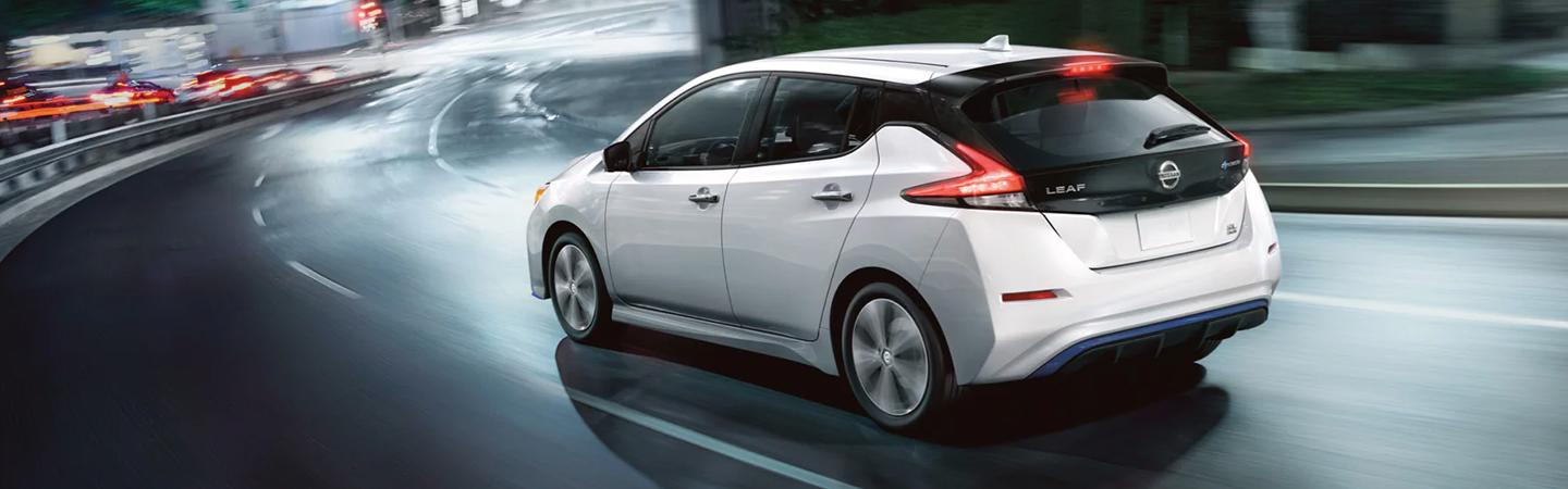 back view of a 2022 Nissan Leaf driving in the city