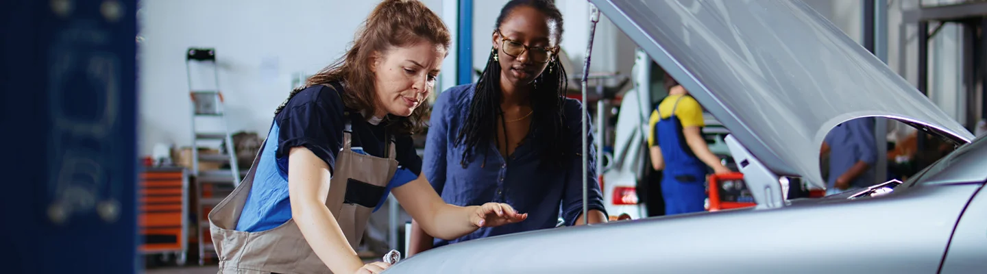 2 mechanics working on car engine