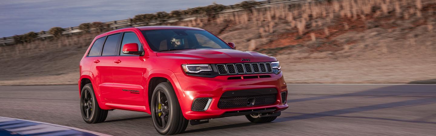 A red 2021 Grand Cherokee L in motion