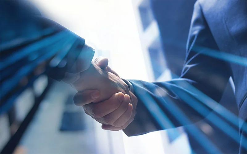 2 men in suits shaking hands