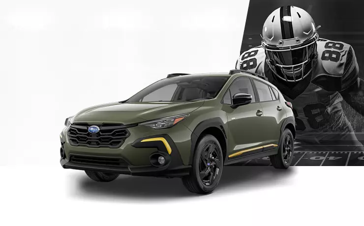 Subaru with football player behind the vehicle