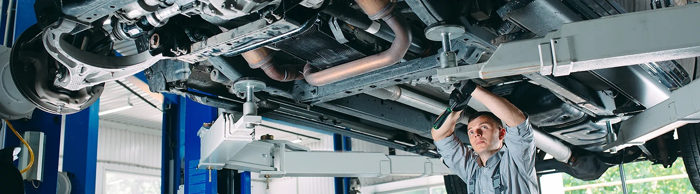 mechanic under vehicle working