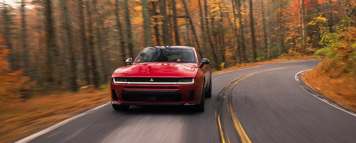 2026 Dodge Charger driving on a road in fall
