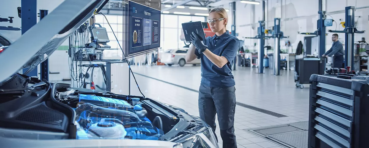 Service mechanic working under the hood of a vehicle