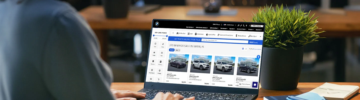 man sitting at laptop doing a Custom Build BMW