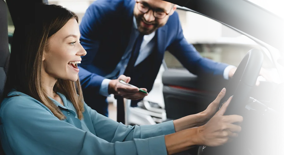 Sales person talking to cusomter about a certified pre-owned car she wants to buy