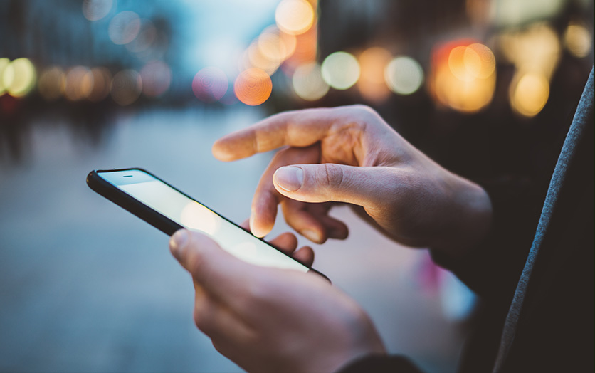 hands with smartphone in them out on the street