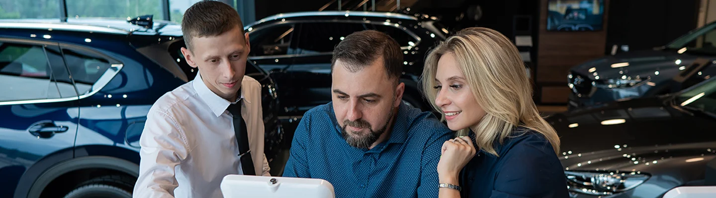 looking at tablet in car showroom