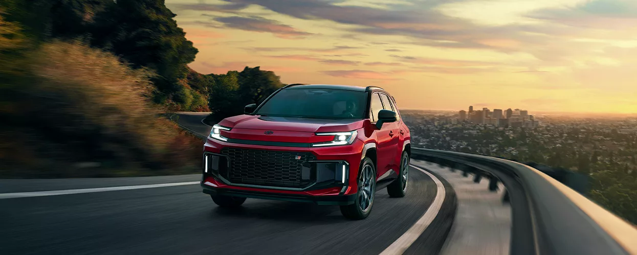 a red Toyota RAV4 on a turn