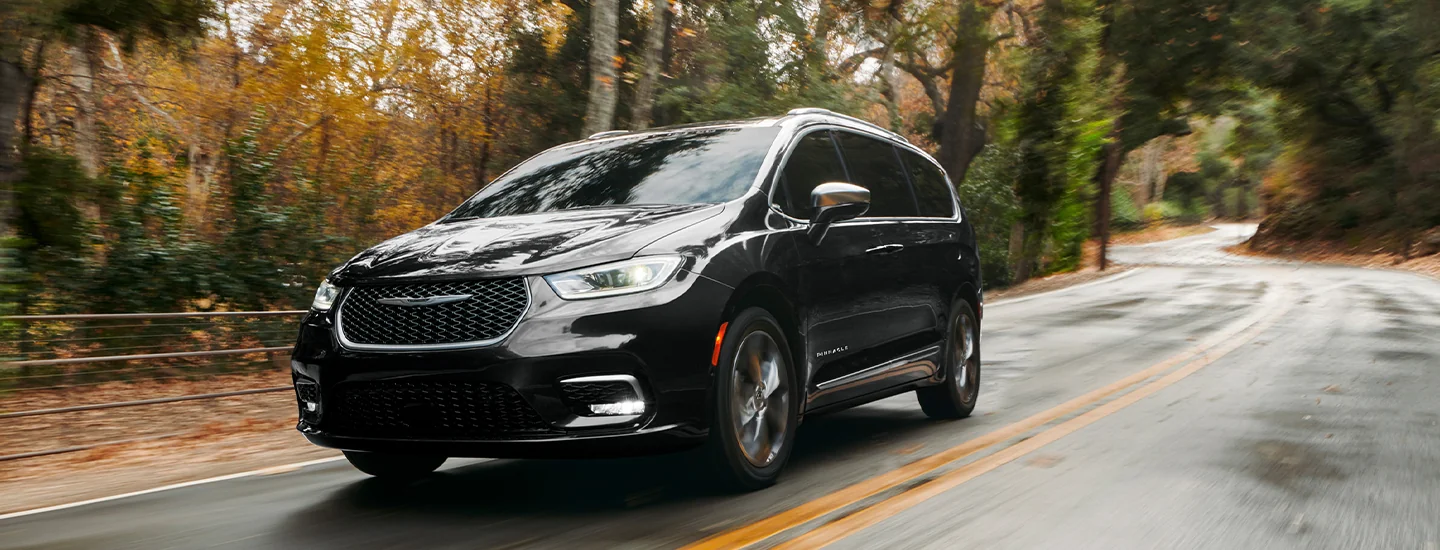 2026 Chrysler Pacifica driving through a country road