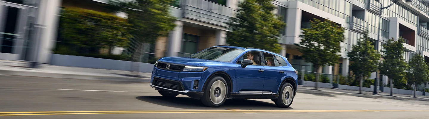 2025 Honda Prologue driving down a city street