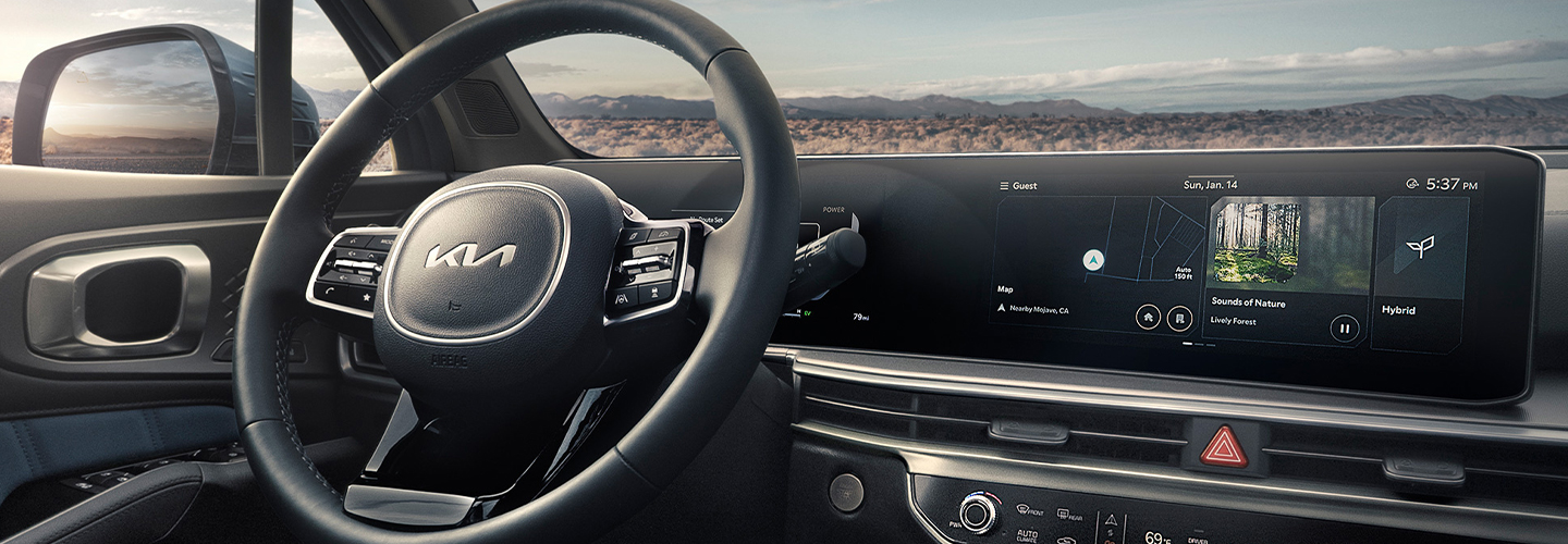 Interior view of the driver seat dashboard and tech of a 2025 Kia Sorento Hybrid