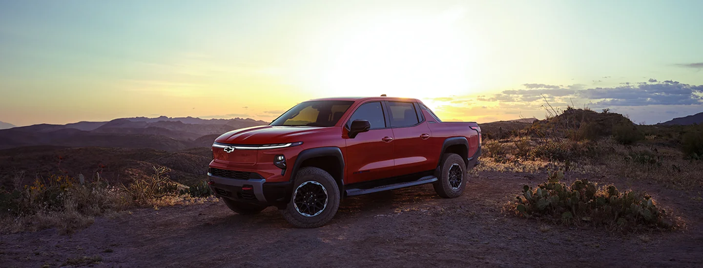 2026 Chevrolet Silverado EV parked on a mountain with the sunset in the background
