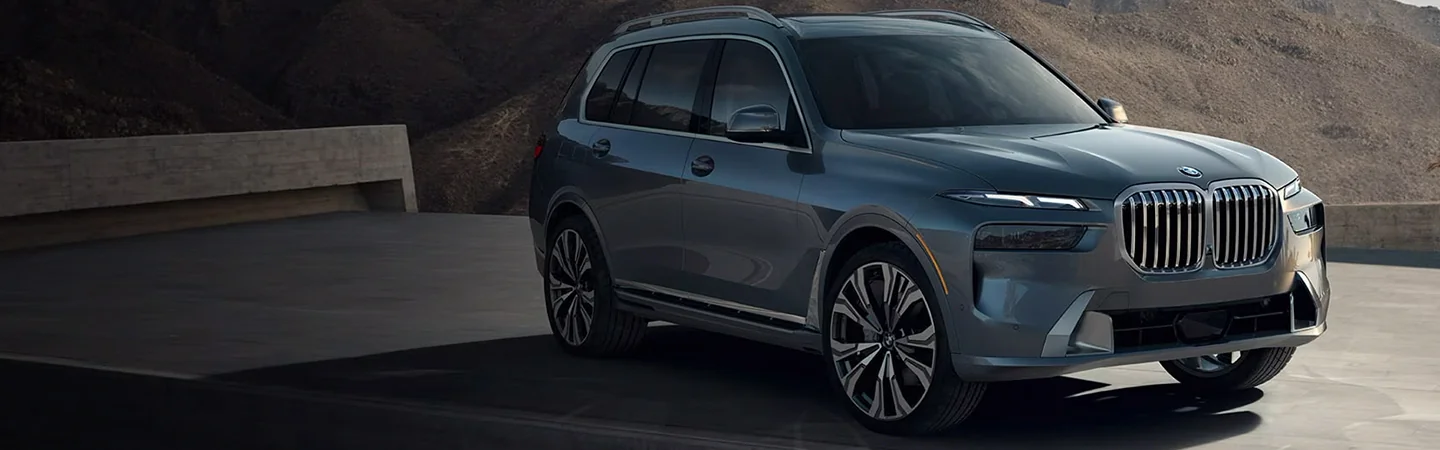 A grey 2025 BMW X7 parked in a parking lot