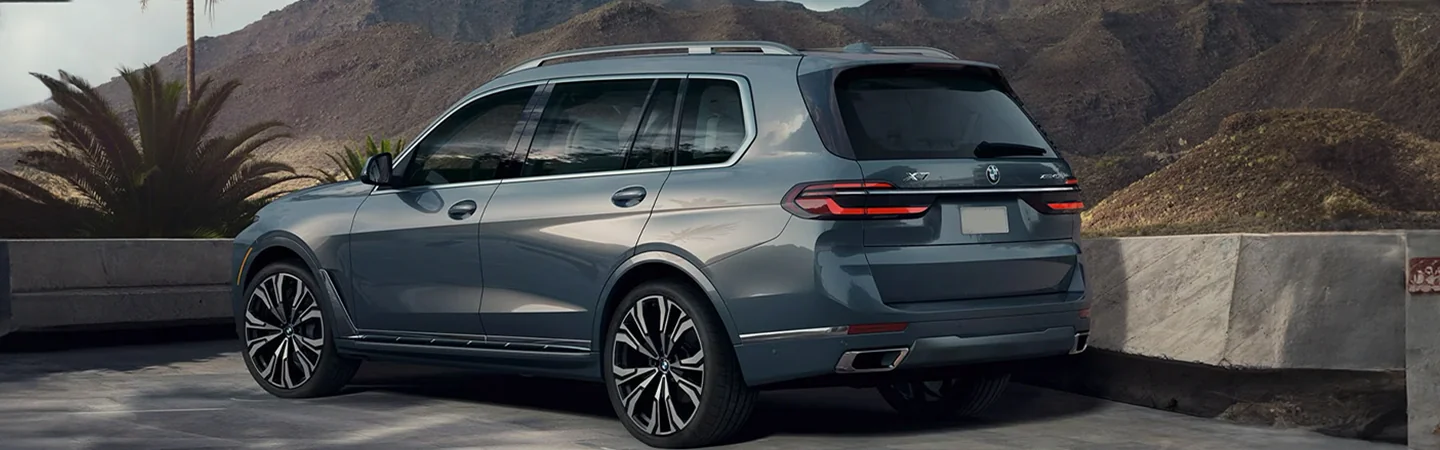 Side back view view of a parked gray 2025 BMW X7 