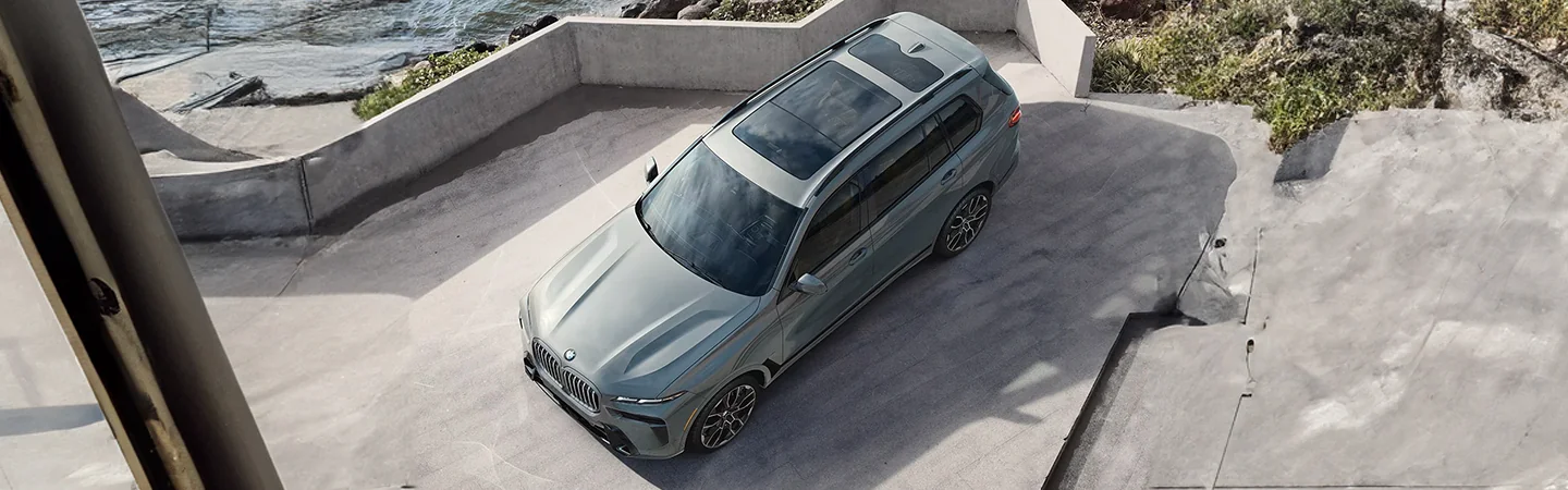 Top view of a parked 2025 BMW X7 in frotn of a building