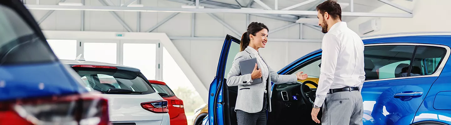 Car salesperson with a customer at Jerry Ulm CDJR