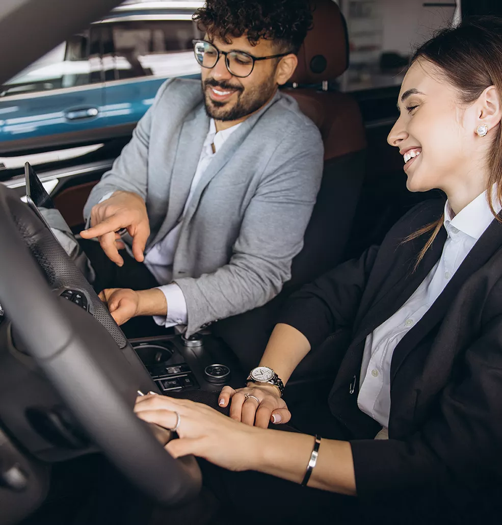 view of two people in Honda Civic with view of the interior technology display