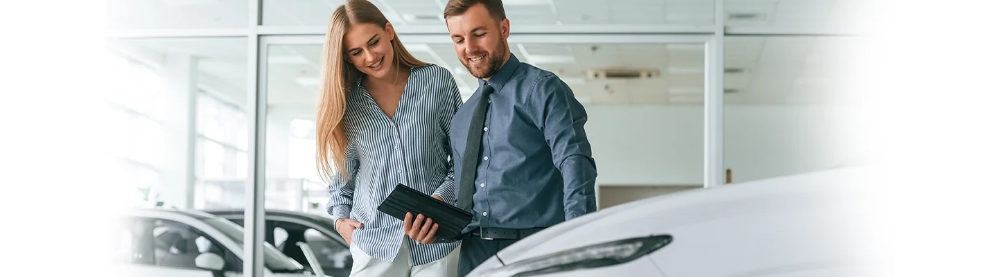Salesperson showing a new INFINITI to a customer