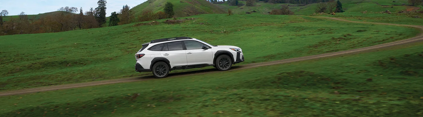 white 2025 Subaru Outback climbing hill