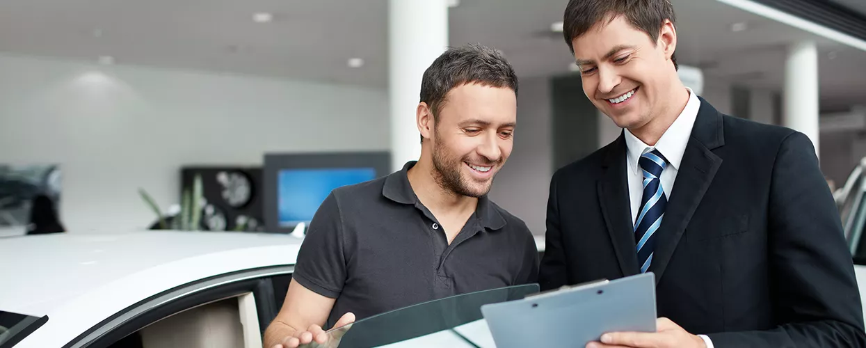 Car salesman talking to a customer about a contract
