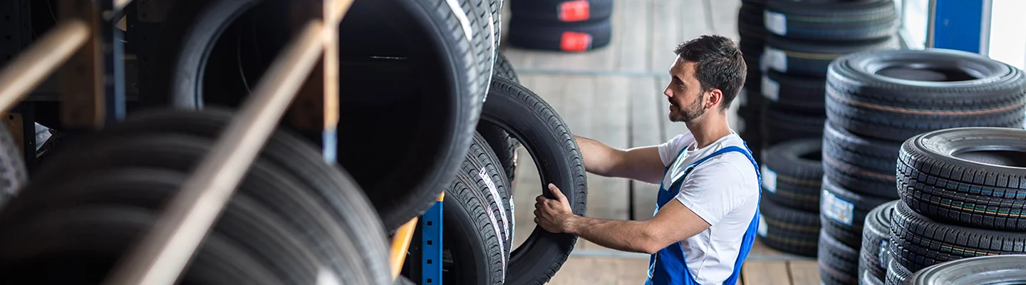 Service tech getting new tires to put on a new Volkswagen