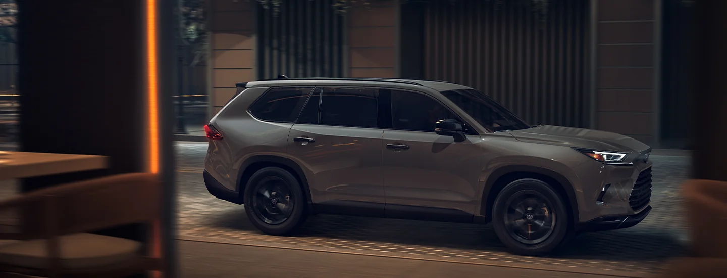 Side view of the 2025 Toyota Grand Highlander parked in on a city street