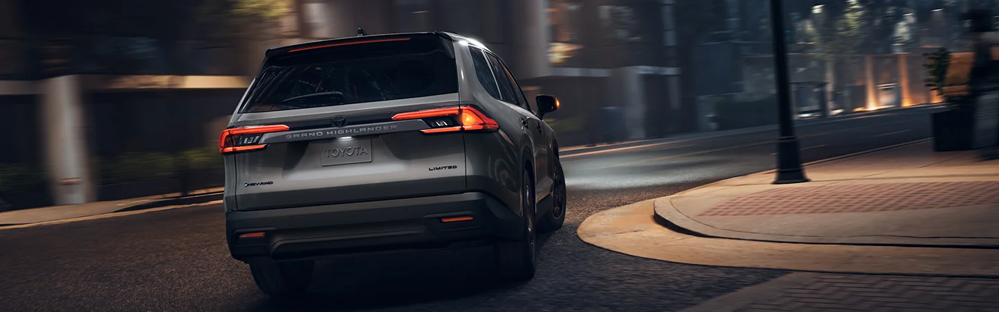 2025 Toyota Grand Highlander driving through the city at night