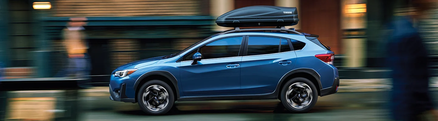 blue Subaru Crosstrek with rack storage on top