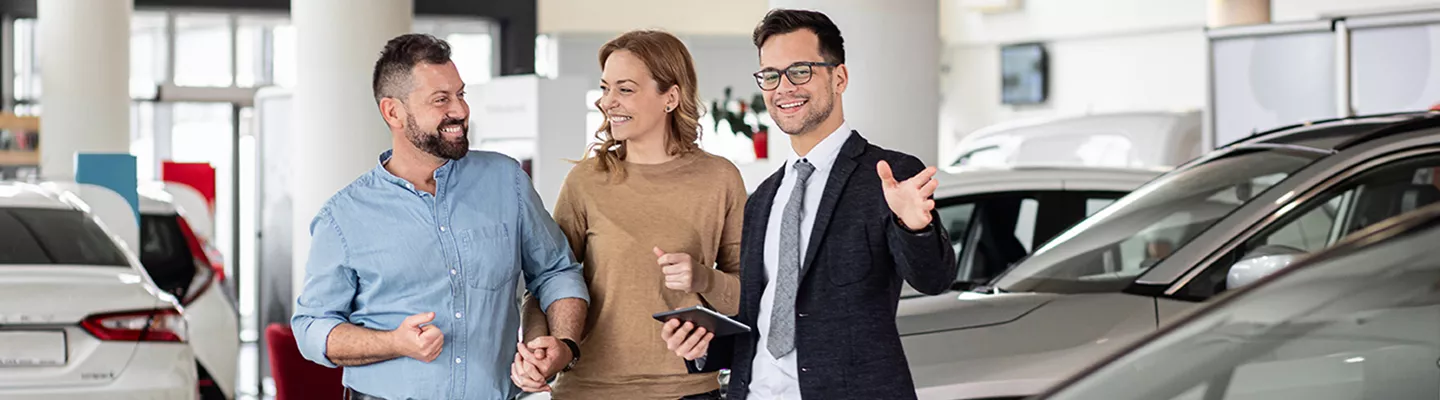 Car salesperson speaking with customers at Jerry Ulm Chrysler Dodge Jeep Ram in Tampa, FL