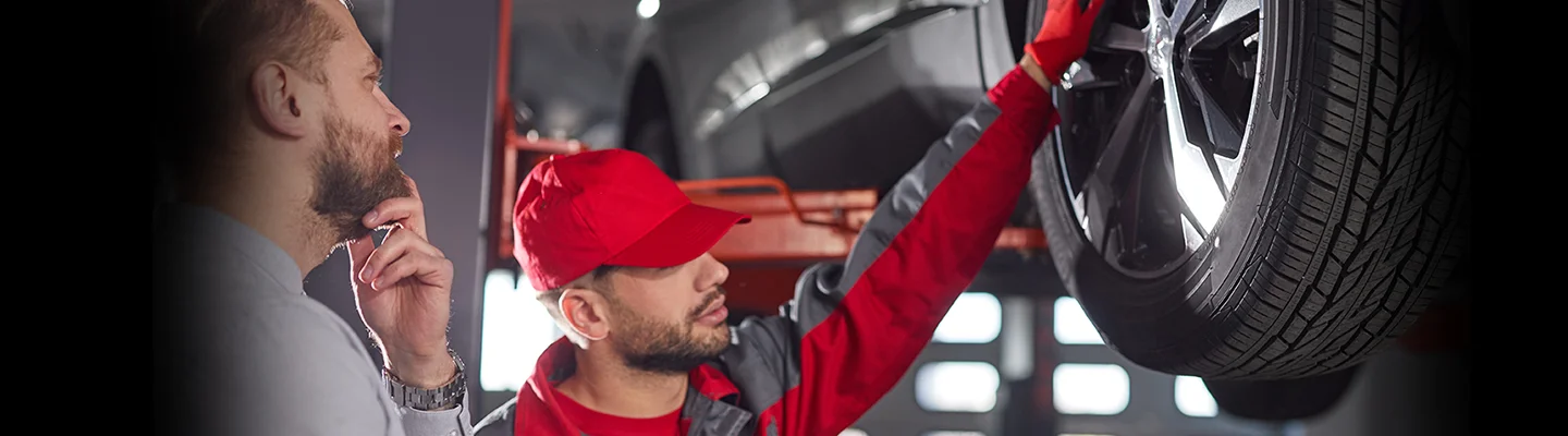 Car salesman showing information to a customer on a tablet