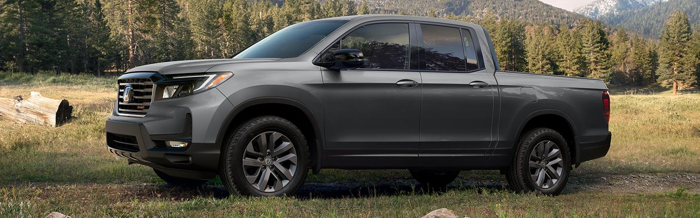 2022 Honda Ridgeline parked on grass left side view 