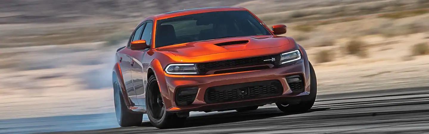 Orange 2022 Dodge Charger smoking its tires
