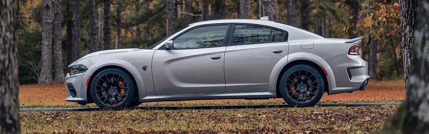 Side view of a parked 2022 Dodge Charger in the woods