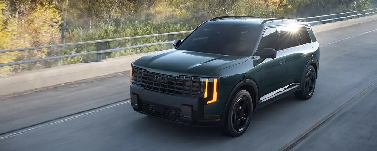 2027 Kia Seltos driving down a road