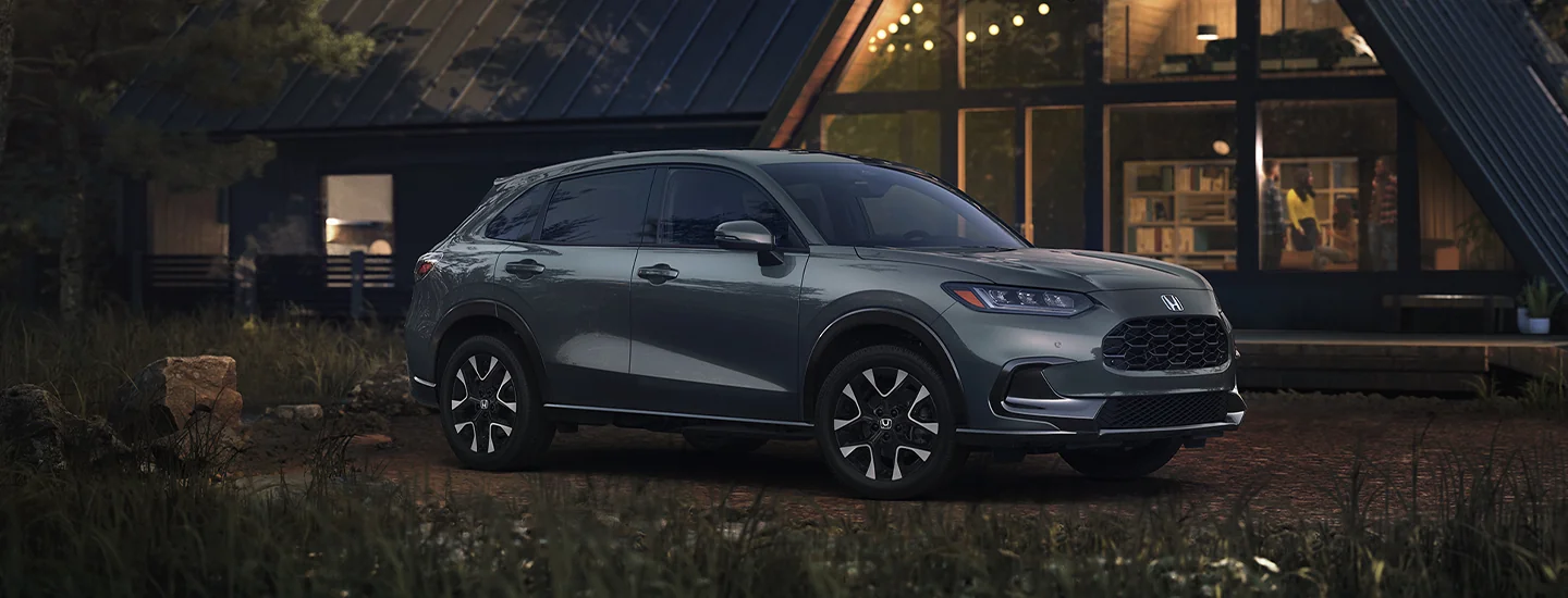 Front view of the 2026 Honda HR-V parked in front of a camp at night
