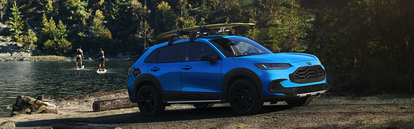 2026 Honda HR-V parked in front of a lake with paddleboarders in the background