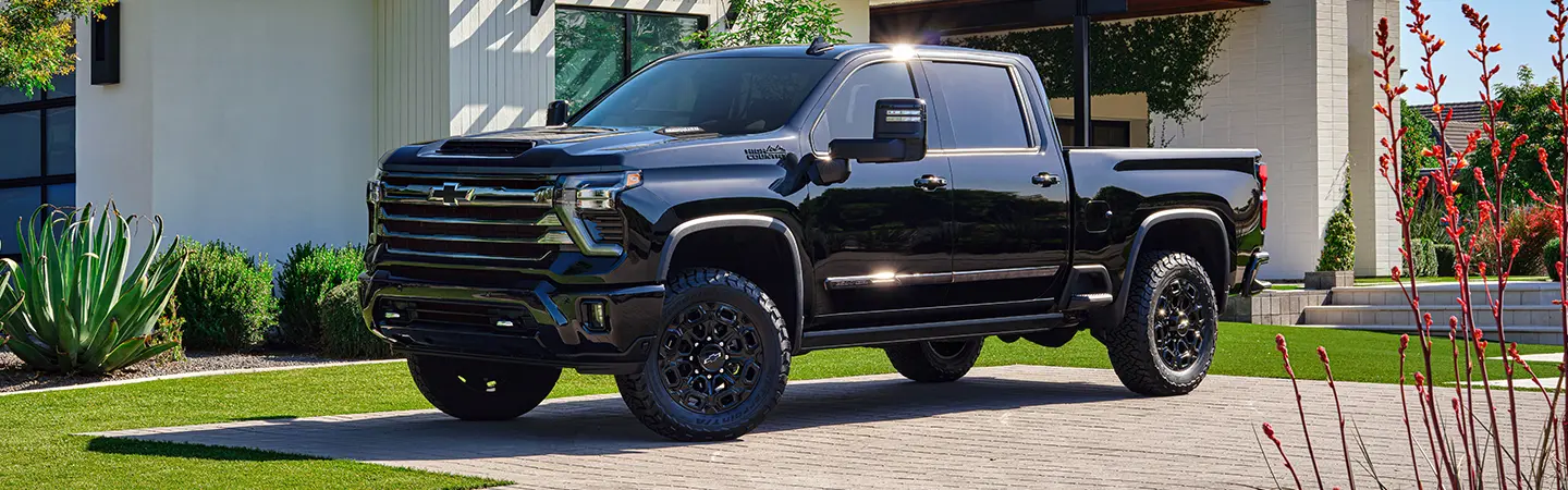 2024 Chevrolet Silverado vs Ford F-150 front view and color blue