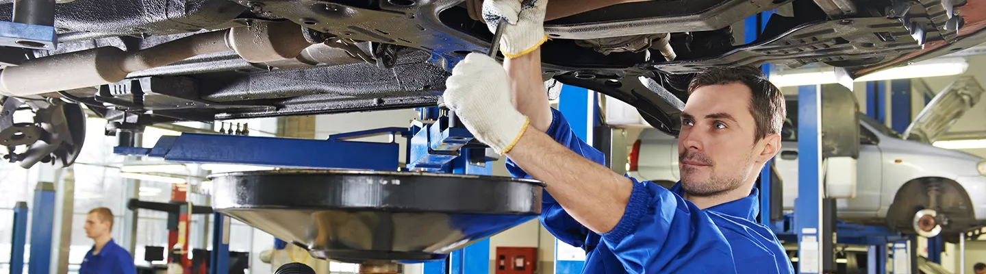 Service technician inspecting an INFINITI QX60