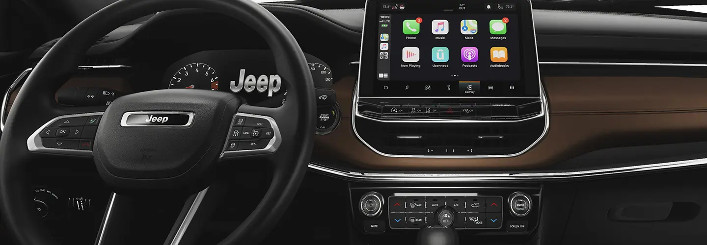 Close up Interior view of the stearing wheel and tech of a 2025 Jeep Compass