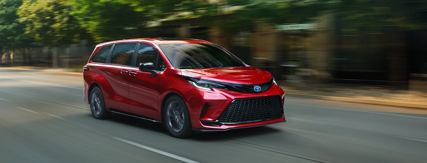 a red 2025 Toyota Sienna in motion